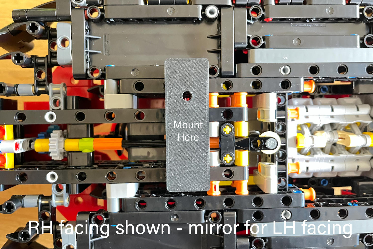 Underside view of LEGO Technic Ferrari SF-24 F1 car (set 42207) with the wall mount bracket in position