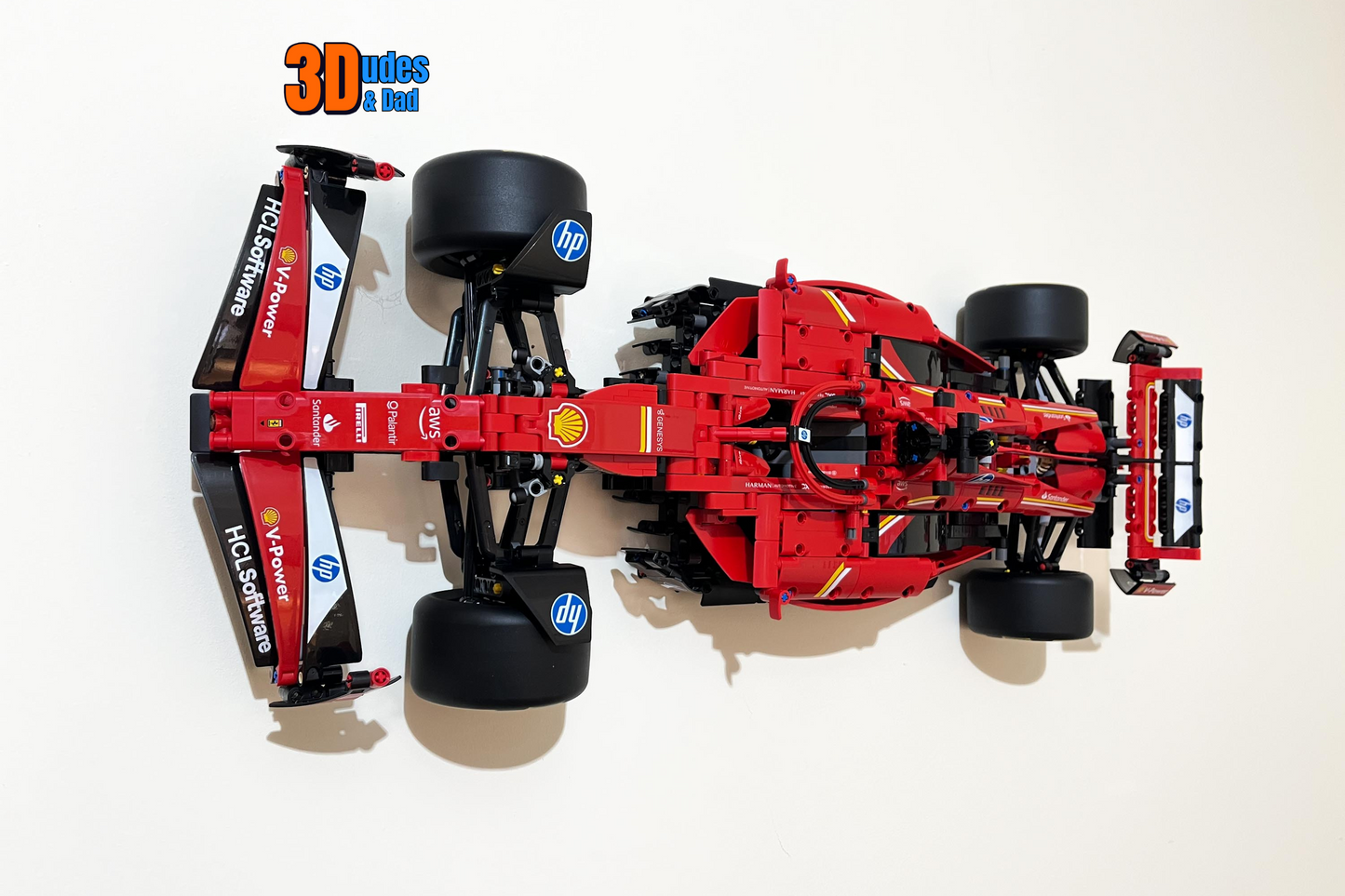 Isometric view of the 3Dudes & Dad display bracket mounting LEGO Technic Ferrari SF-24 F1 car (set 42207) securely on a wall